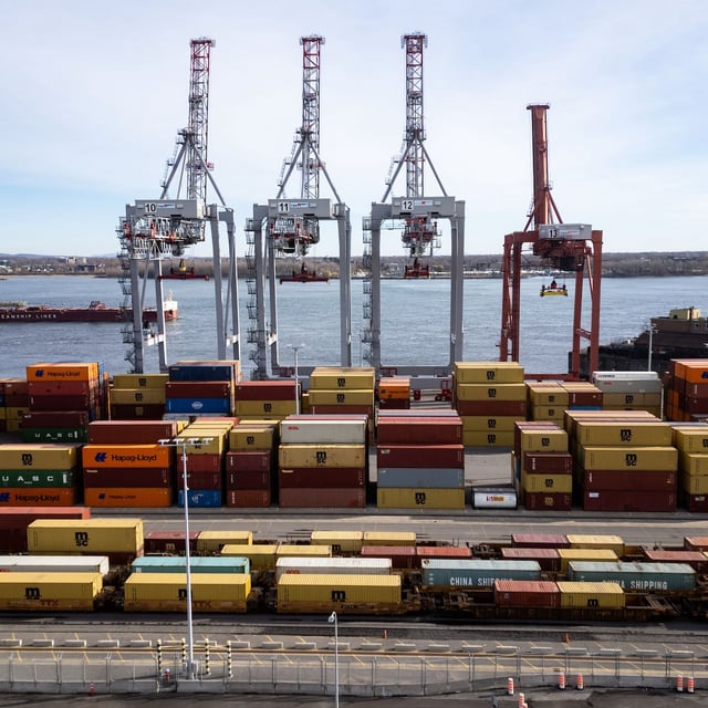 An aerial view shows a ship sailing past the Port of Montreal in Montreal on Thursday, Nov.14, 2024.  THE CANADIAN PRESS/Christinne Muschi