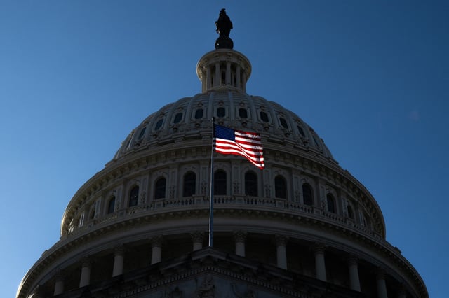 A US flag flies near the dome of the US Capitol in Washington, DC, February 25, 2025. 