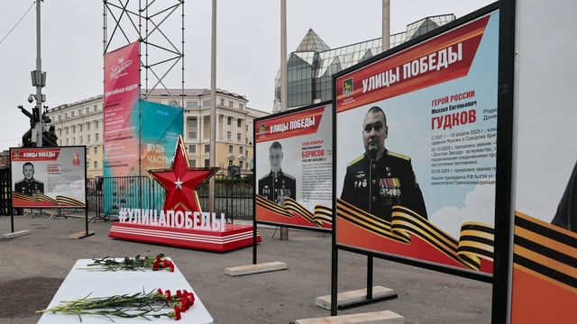 A view shows flowers placed on a table in front of a board with a photograph of Major General Mikhail Gudkov, the deputy head of the Russian Navy, in the far eastern city of Vladivostok, Russia, July 3, 2025.