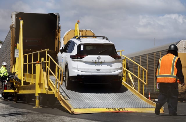 A new Nissan Rogue is driven onto a rail car to be transported from an automobile processing terminal located at the Port of Los Angeles on April 3, 2024 in Wilmington, California.