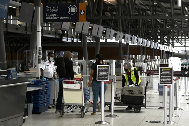 People check baggage at the Departures Terminal of the Ottawa Airport in Ottawa, on Monday, June 14, 2021. THE CANADIAN PRESS/Justin Tang