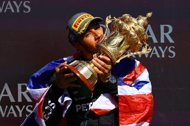 Race winner Lewis Hamilton of Great Britain and Mercedes celebrates on the podium during the F1 Grand Prix of Great Britain at Silverstone Circuit on July 07, 2024 in Northampton, England.