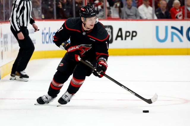 FILE – Carolina Hurricanes’ Dmitry Orlov (7) controls the puck against the New Jersey Devils during the second period of Game 2 of an NHL hockey Stanley Cup first-round playoff series in Raleigh, N.C., Tuesday, April 22, 2025. (AP Photo/Karl DeBlaker, File)