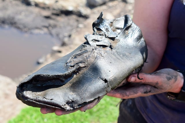 A handout photo released by The Vindolanda Trust shows a complete leather shoe, one of 32 shoes uncovered so far during excavations in Northern England