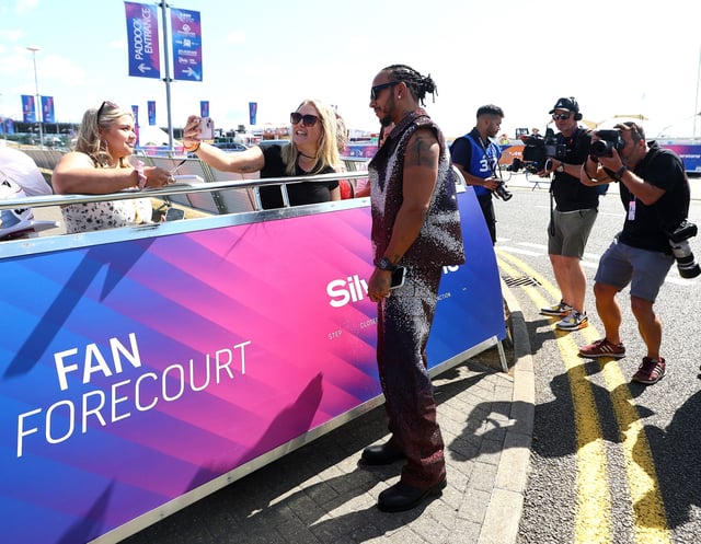 Formula One F1 - British Grand Prix - Silverstone Circuit, Silverstone, Britain - July 3, 2025 Ferrari's Lewis Hamilton poses for a picture with a fan ahead of the British Grand Prix REUTERS/Andrew Boyers