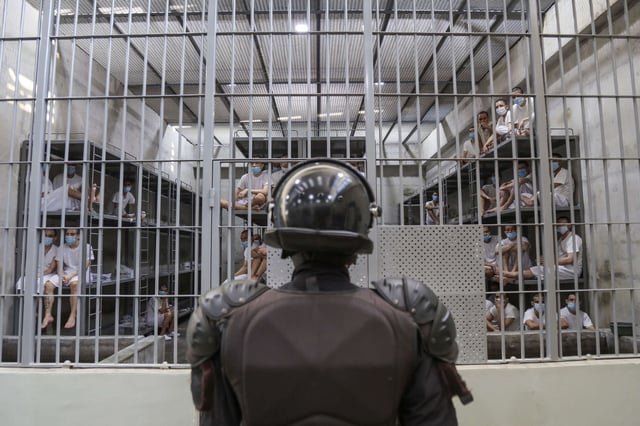 A prison officer guards a cell at maximum security penitentiary CECOT (Center for the Compulsory Housing of Terrorism) on April 4, 2025, in Tecoluca, San Vicente, El Salvador.