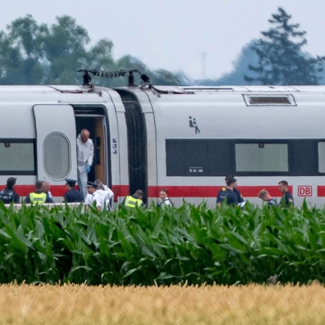 Police and forensics are investigating an ICE train in which a man attacked several passengers in Strasskirchen, Germany, Thurdsday, July 3, 2025. (Armin Weigel/dpa via AP)