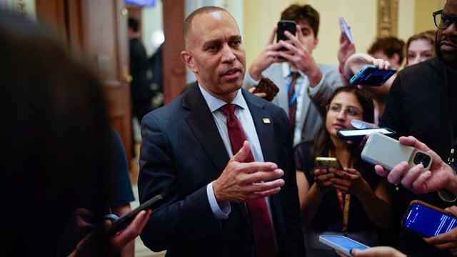 US House Minority Leader Hakeem Jeffries, Democrat of New York, talks to reporters as he leaves the House floor.