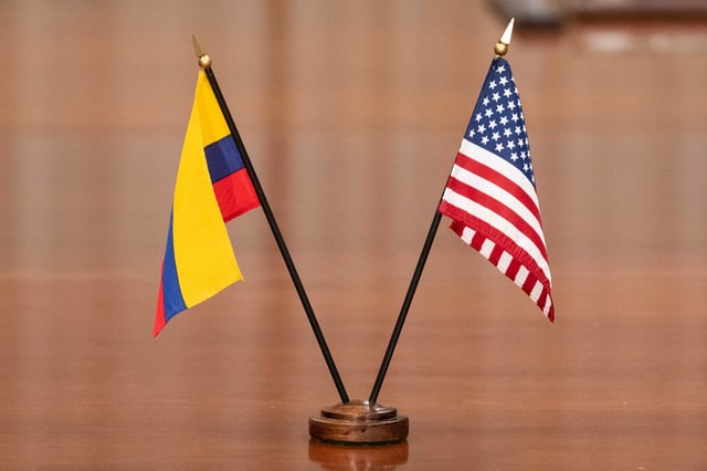 FILE - The Colombian and U.S. flags decorate the table as U.S. Secretary of Defense Lloyd Austin meets with Colombian Defense Minister Ivan Velasquez at the Pentagon, Nov. 29, 2022, in Washington. (AP Photo/Alex Brandon, File)