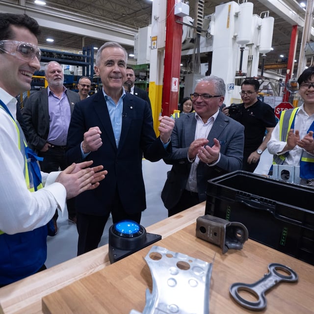 Liberal leader Mark Carney reacts as he participates in a demonstration during a tour of an auto parts factory on Friday, April 4, 2025 in Vaughan, Ont. THE CANADIAN PRESS/Adrian Wyld