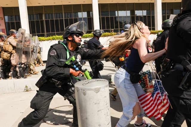 Protesters face off with police outside of a federal building in Los Angeles in June for an anti-Trump &#34;No Kings Day&#34; demonstration in a city that has been the focus of protests against Trump&#39;s immigration raids.  (SPENCER PLATT/GETTY IMAGES)