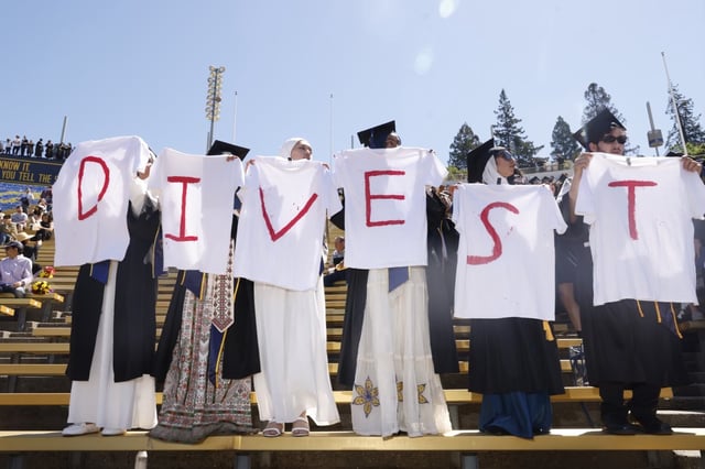 Pro-Palestinian demonstrators held T-shirts encouraging UC Berkeley to divest from Israel during commencement at Memorial Stadium in May 2024.