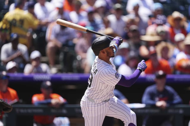 Colorado Rockies&#39; Thairo Estrada follows the flight of his two-run home run off Houston Astros starting pitcher Brandon Walter in the first inning of a baseball game Thursday, July 3, 2025, in Denver. (AP Photo/David Zalubowski)