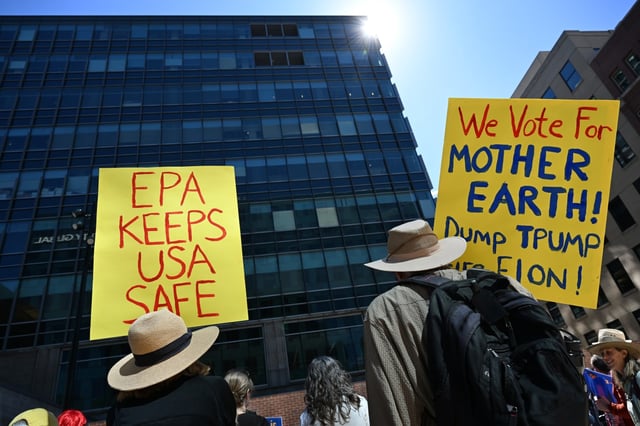 People hold up signs during a rally in support of federal workers at the Plaza of the Americas next to the EPA Region 8 office in Denver on March 26, 2025. The EPA building is in the seen in front of the protesters. The American Federation of Government Employees Local 3607 held the rally to support Environmental Protection Agency workers. The event was organized by American Federation of Government Employees labor union members. (Photo by Helen H. Richardson/The Denver Post)
