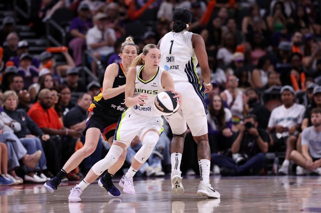 Paige Bueckers #5 dribbles around a screen set by NaLyssa Smith #1 of the Dallas Wings on Sami Whitcomb #33 of the Phoenix Mercury during the second half of a WNBA Commissioner&#39;s Cup game at PHX Arena on June 11, 2025 in Phoenix, Arizona. The Mercury defeated the Wings 93-80.