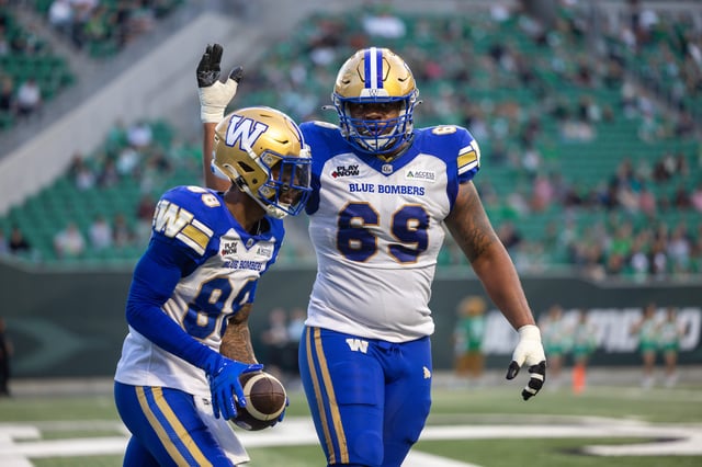 Keric Wheatfall #88 and Kendall Randolph #69 of the Winnipeg Blue Bombers celebrate after a touchdown in the pre-season game between the Winnipeg Blue Bombers and Saskatchewan Roughriders at Mosaic Stadium on May 30, 2025 in Regina, Canada.