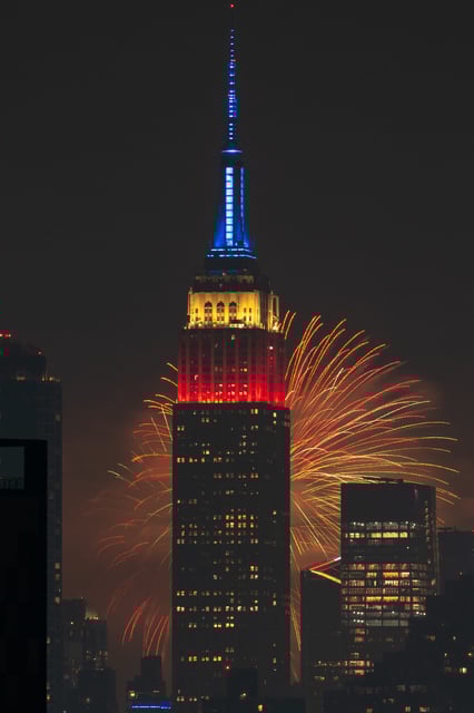 The Macy's 4th Of July fireworks light up the night sky as a backdrop to the Empire State Building on July 4, 2024 in New York City.