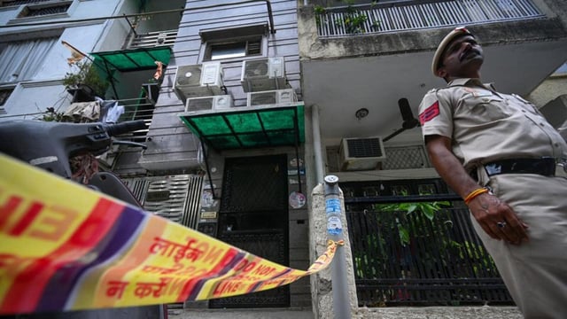 Police officials were seen outside the house in F Block, Lajpat Nagar I, where the bodies of a mother and her son were found on Wednesday night in New Delhi, on Thursday. (Sanchit Khanna/HT)