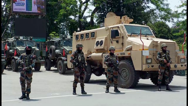Security forces stand guard after the overnight violence that erupted in five districts of Imphal Valley in June. (ANI PHOTO)