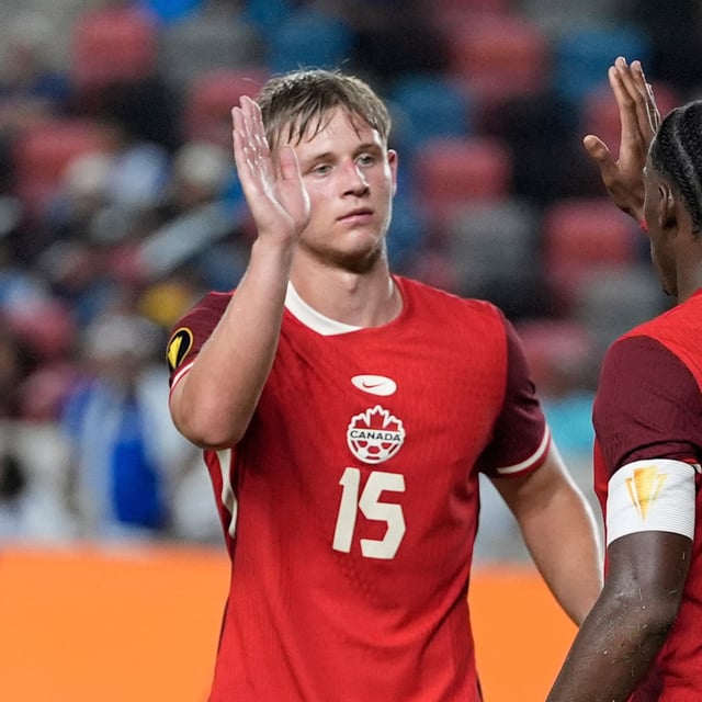 Canada forward Jonathan David (10) celebrates with defender Luc De Fougerolles (15) after scoring during a CONCACAF Gold Cup soccer match against El Salvador in Houston, Tuesday, June 24, 2025. (AP Photo/Ashley Landis)