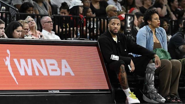 Damian Lillard courtside at a WNBA game.