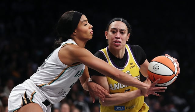 Sparks forward Dearica Hamby drives as the New York Liberty’s Isabelle Harrison defends during the second half on Thursday night in New York. The Sparks lost, 89-79. (Photo by Sarah Stier/Getty Images)