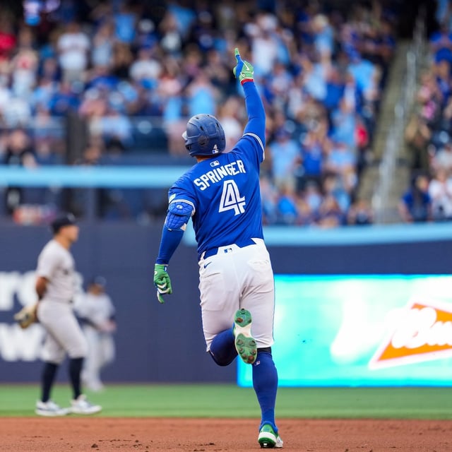 Toronto Blue Jays' George Springer (4) celebrates his two-run home run against the New York Yankees during third inning MLB baseball action, in Toronto on Thursday, July 3, 2025. THE CANADIAN PRESS/Thomas Skrlj