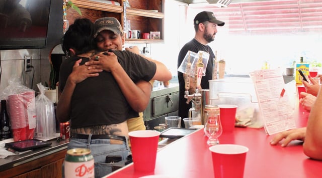 Owner N’Gina Guyton hugs one of her staff, thanking her and her customers at Jim-Denny’s, Wednesday, July 7, 2025. The day was emotional for Guyton, who was thankful for everyone's support.