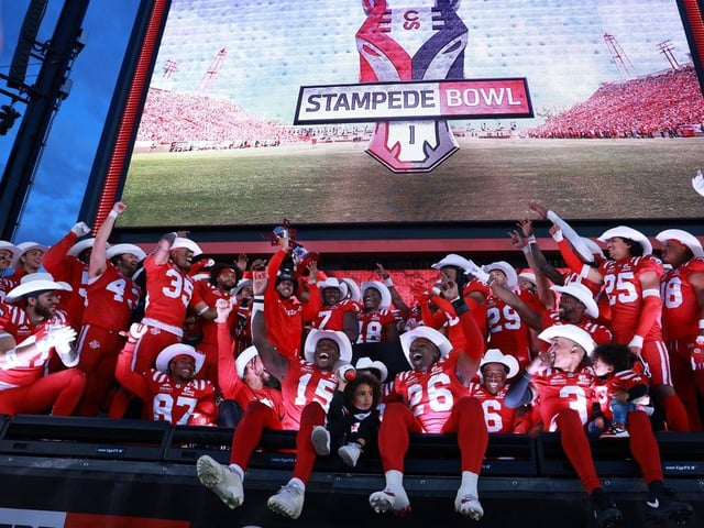  The Stampeders celebrate with the Stampede Bowl trophy.