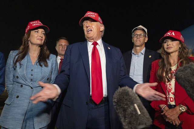 President Donald Trump, center, speaks with reporters as, from left, Agriculture Secretary Brooke Rollins, Rep. Zachary Nunn, R-Iowa, Rep. Randy Feenstra, R-Iowa, and Homeland Security Secretary Kristi Noem listen as they arrive on Friday, July 4, 2025, at Joint Base Andrews, Md. (AP Photo/Alex Brandon)