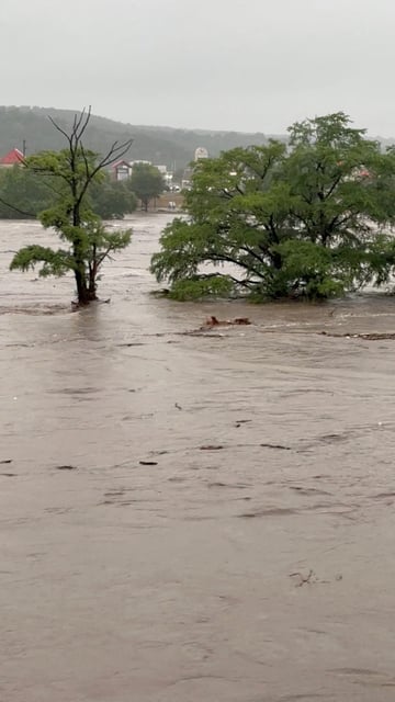 Trees stand partially submerged after storms caused massive flooding from the swollen Guadalupe River in Kerrville, Texas, U.S., July 4, 2025 in this still image from video obtained from social media. Michael Moad/via REUTERS  THIS IMAGE HAS BEEN SUPPLIED BY A THIRD PARTY. MANDATORY CREDIT. NO RESALES. NO ARCHIVES.
