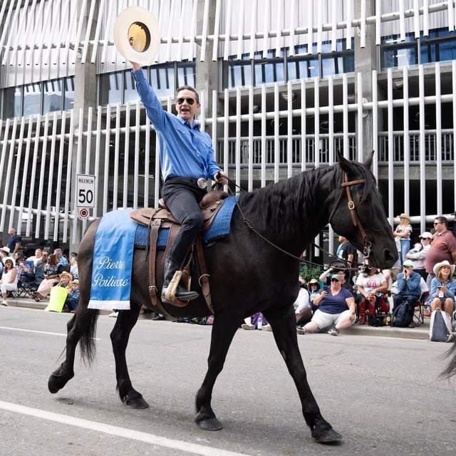 Conservative Leader Pierre Poilievre rides a horse at the Calgary Stampede parade on Friday.