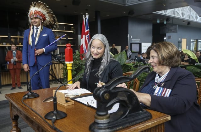Manitoba Premier Wab Kinew looks on as Nahanni Fontaine, Minister of Families, Minister responsible for Accessibility, Minister responsible for Gender Equity is sworn-in by Lt. Gov. Anita Neville at a Premier and cabinet swearing-in ceremony in Winnipeg, Wednesday, Oct. 18, 2023. THE CANADIAN PRESS/John Woods