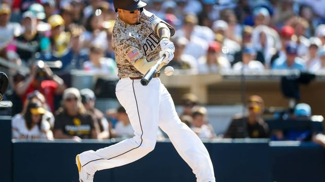 Jul 4, 2025; San Diego, California, USA; San Diego Padres third baseman Manny Machado (13) hits a one run home run during the fourth inning against the Texas Rangers at Petco Park. Mandatory Credit: David Frerker-Imagn Images