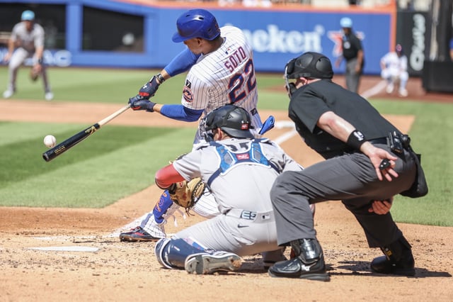 Jul 4, 2025; New York City, New York, USA;  New York Mets right fielder Juan Soto (22) hits a double in the third inning against the New York Yankees at Citi Field. Wendell Cruz-Imagn Images