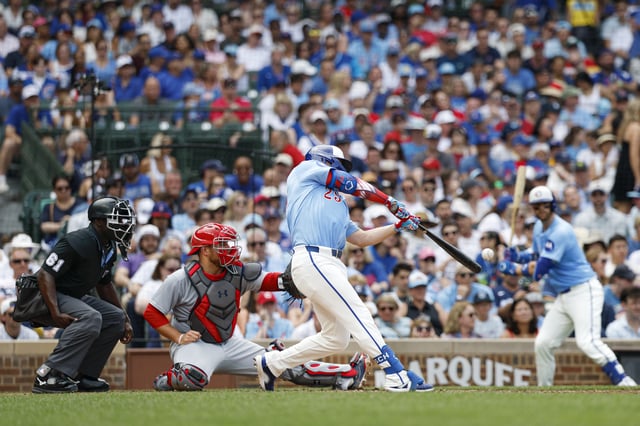Jul 4, 2025; Chicago, Illinois, USA; Chicago Cubs first baseman Michael Busch (29) hits an RBI-single against the St. Louis Cardinals during the fifth inning at Wrigley Field. Kamil Krzaczynski-Imagn Images