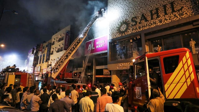 Firefighters try to douse a fire that broke out at a shopping complex, at Karol Bagh in New Delhi, Friday, July 4, 2025.