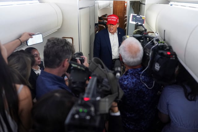 U.S. President Donald Trump speaks to members of the media on board Air Force One on the way to New Jersey, U.S., July 4, 2025. REUTERS/Nathan Howard