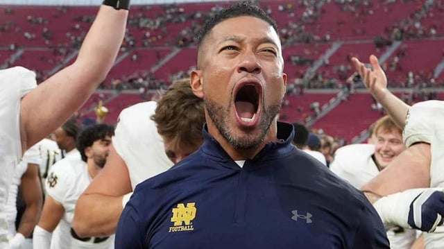 Nov 30, 2024; Los Angeles, California, USA; Notre Dame Fighting Irish head coach Marcus Freeman celebrates with players at the end of the game against the Southern California Trojans at United Airlines Field at Los Angeles Memorial Coliseum.
