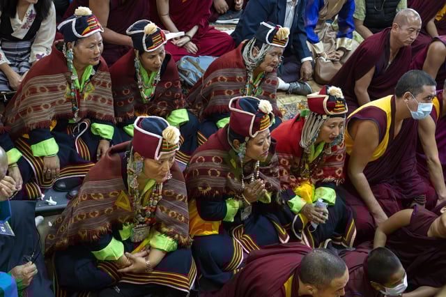 Devotees watch Tibetan spiritual leader the Dalai Lama on a television screen at an event during which Tibetan exiles prayed for the Tibetan leader's longevity, a day before his 90th birthday, in Dharamshala, India, Saturday, July 5, 2025.(AP Photo/Ashwini Bhatia)