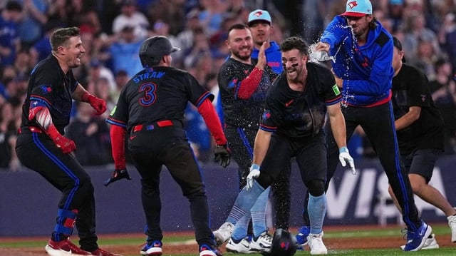 Jul 4, 2025; Toronto, Ontario, CAN; Toronto Blue Jays third baseman Ernie Clement (22) celebrates the win with outfielder Myles Straw (3) against the Los Angeles Angels during  the tenth inning at Rogers Centre. Mandatory Credit: Nick Turchiaro-Imagn Images