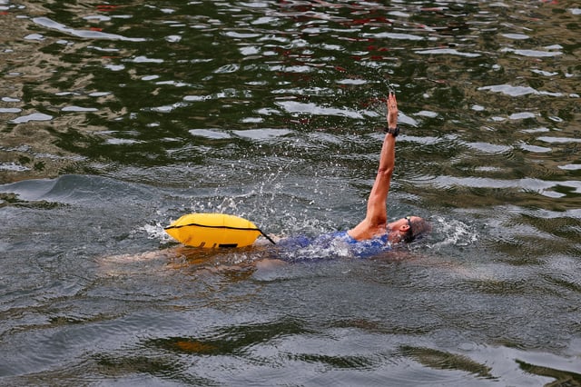 A person swims in the River Seine at the Bras Marie site, opened to swimmers marking the first public bathing session in the capital's historic waterway, in Paris, France, July 5, 2025. REUTERS/Abdul Saboor
