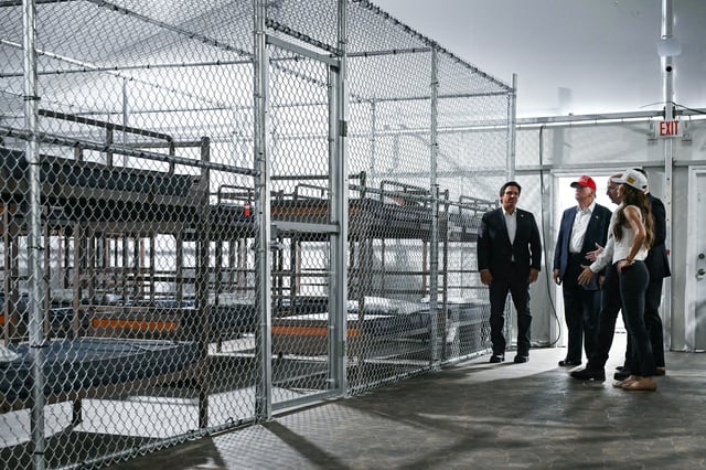 President Donald Trump, Florida Governor Ron DeSantis and Secretary of Homeland Security Kristi Noem tour a migrant detention center, dubbed "Alligator Alcatraz," located at the site of the Dade-Collier Training and Transition Airport in Ochopee, Florida on July 1, 2025. 