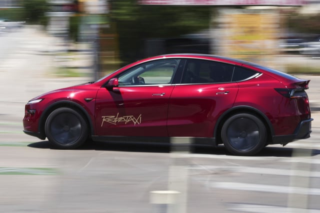A driverless Tesla robotaxi, a ride-booking service, moves through traffic, Sunday, June 22, 2025, in Austin, Texas.