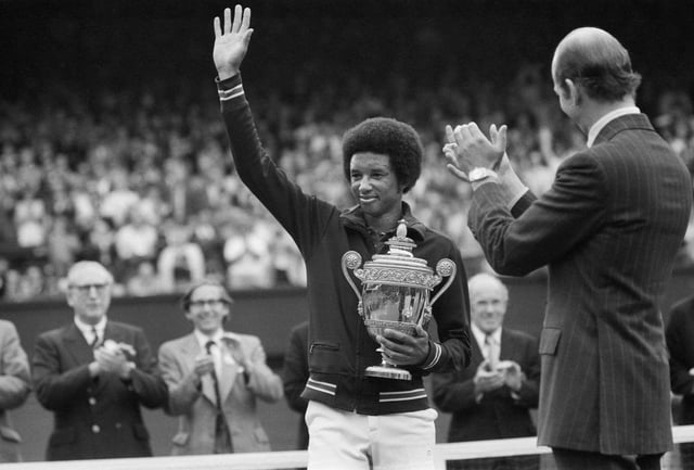 Arthur Ashe with the Wimbledon trophy after he beat the defending champion Jimmy Connors in four sets, 6-1, 6-1, 5-7, 6-4 6th July 1975. (Photo by Staff/Mirrorpix/Getty Images)