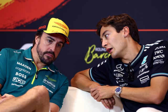 Fernando Alonso of Spain and Aston Martin F1 Team and George Russell of Great Britain and Mercedes AMG Petronas F1 Team talk in the Drivers Press Conference during previews ahead of the F1 Grand Prix of Spain at Circuit de Barcelona-Catalunya on May 29, 2025 in Barcelona, Spain.