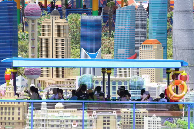 People ride a boat at Legoland Shanghai Resort on its grand opening day, amid an orange alert for heat in Shanghai, China July 5, 2025. REUTERS/Go Nakamura