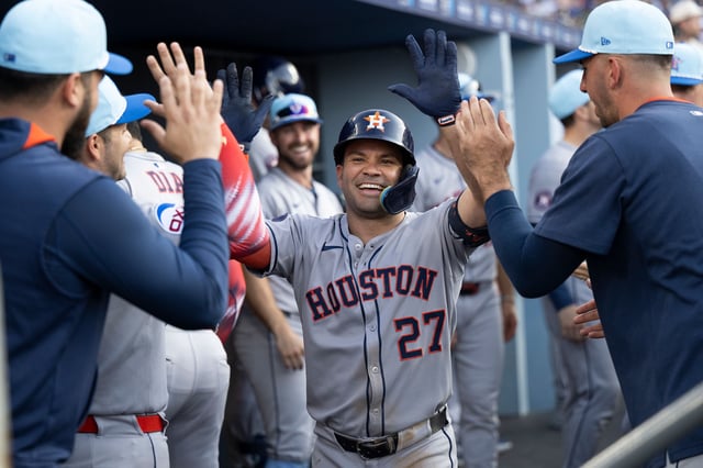 Jose Altuve celebrates in the dugout after his two-run home run during the third inning.