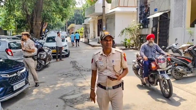 Police personnel during an investigation outside a police station.