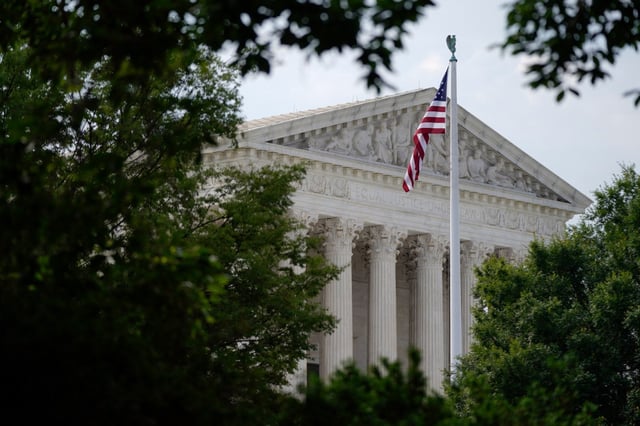 An American flag waves in front of the U.S. Supreme Court building, Monday, June 27, 2022, in Washington. (AP Photo/Patrick Semansky)